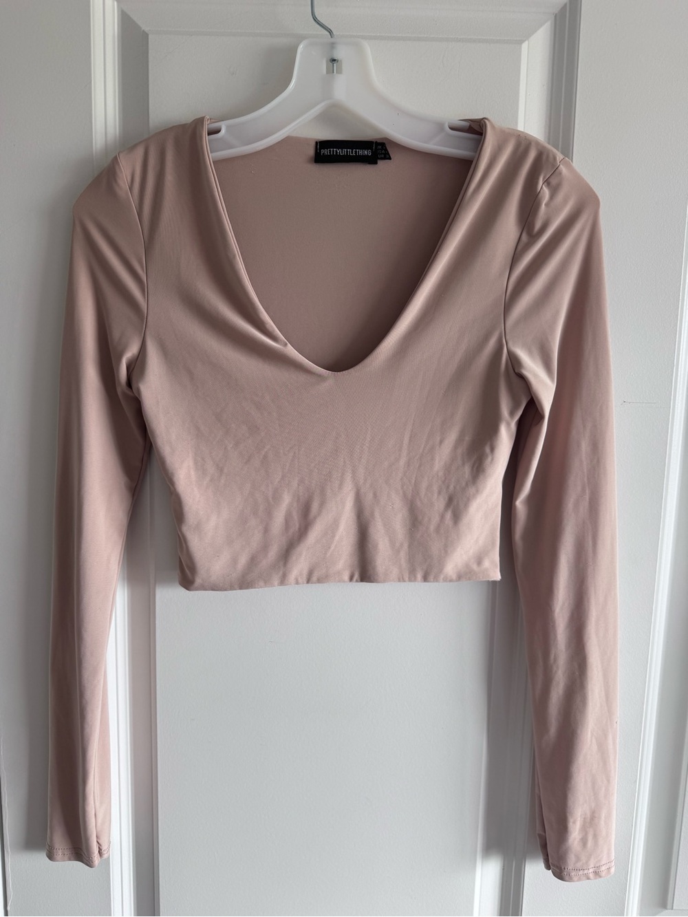PrettyLittleThing long-sleeve crop top features a deep V-neckline
